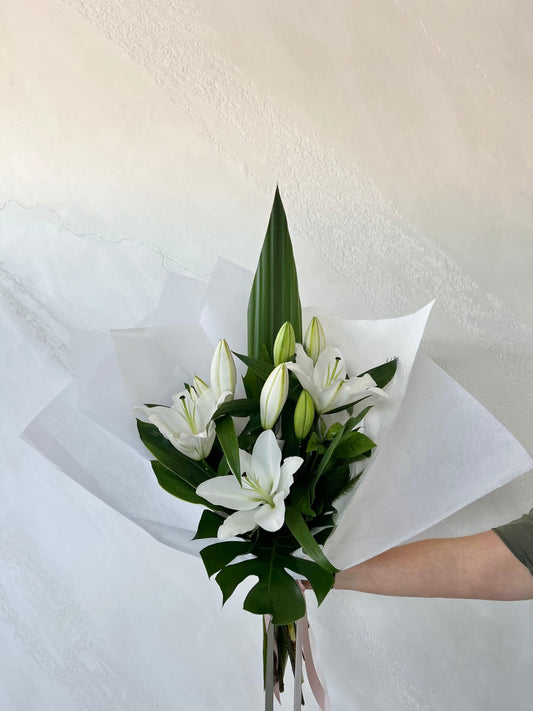 A bouquet of oriental&nbsp;lilies and lush foliage.