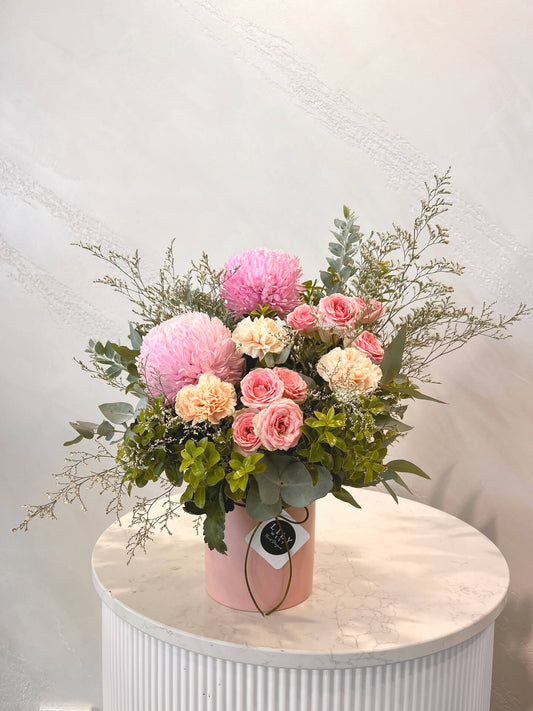 A beautiful ceramic arrangement with mums, carnations and spray roses sure to impress.