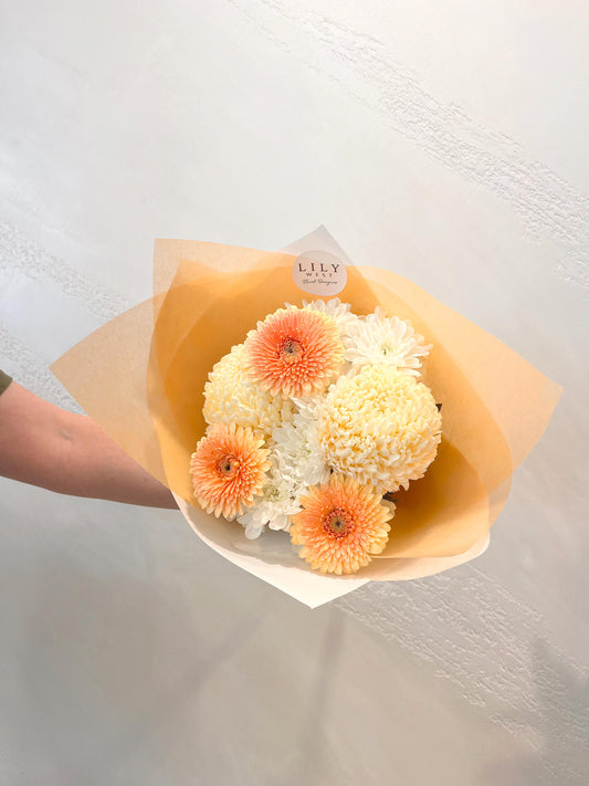 A cute little bouquet including mums, daisies and the very sweet mini gerbera. 