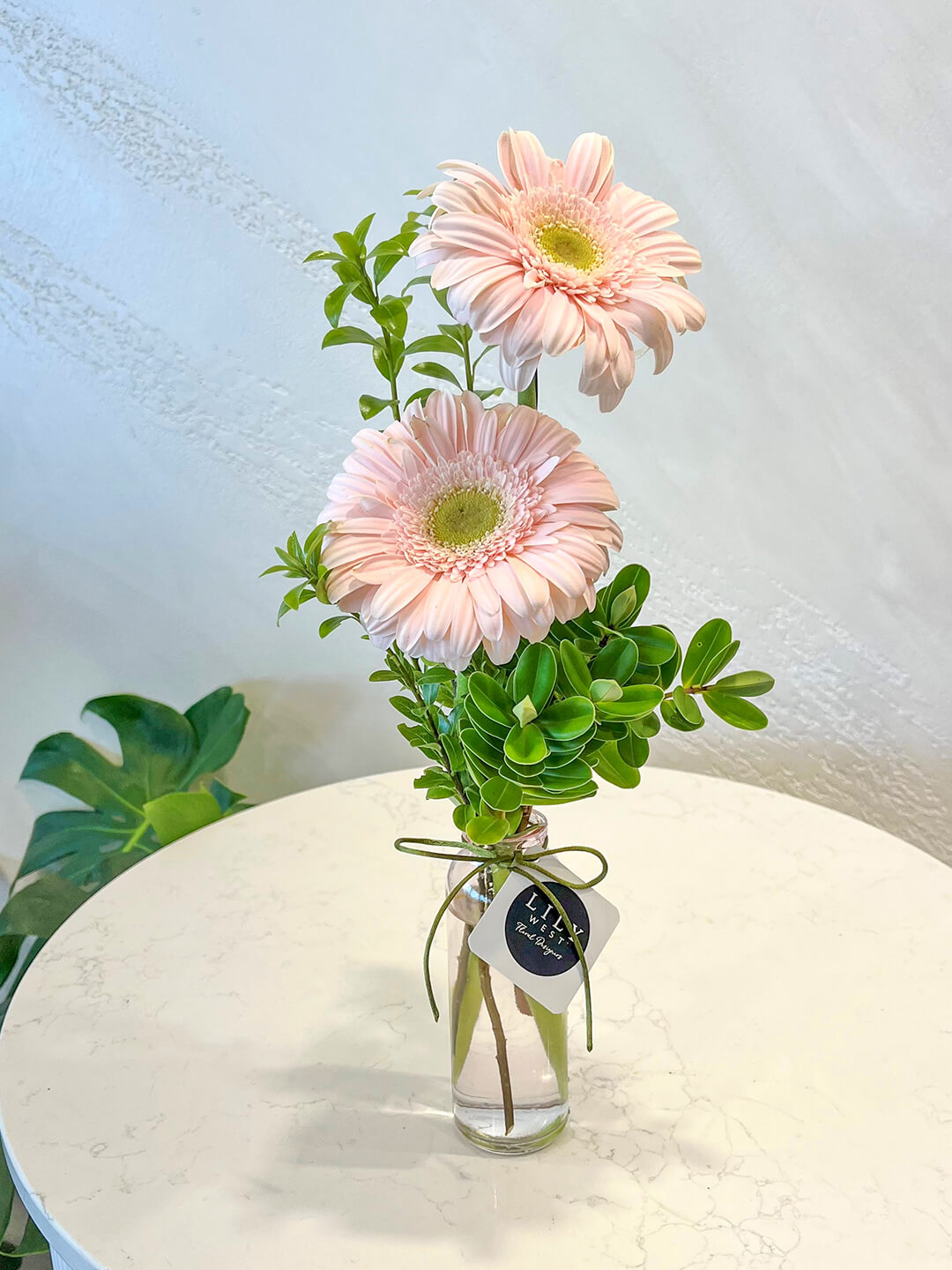 Happy gerberas in a clear bottle, colour may vary.&nbsp;